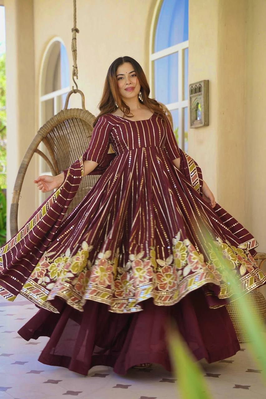 Majestic Maroon Flared Anarkali Suit Set Adorned with Luminous Sequin Stripes and an Ornate Floral Embroidered Hemline